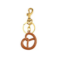 Pretzel Dorado Valmont — Llavero Charm para Bolso | Capricho de Oro